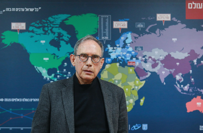 Diaspora Affairs Minister Nachman Shai stands in front of a large map in his ministry’s conference room showing the population of Jewish communities around the globe. (photo credit: MARC ISRAEL SELLEM/THE JERUSALEM POST)