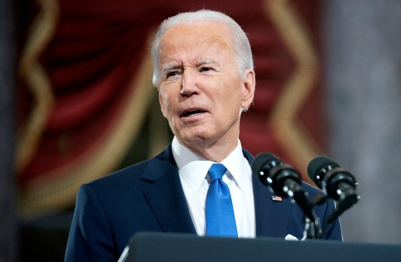 US President Joe Biden delivers remarks in the Statuary Hall of the US Capitol during a ceremony on the first anniversary of the January 6, 2021 attack on the US Capitol by supporters of former President Donald Trump in Washington, D.C., US, January 6, 2022. (photo credit: GREG NASH/POOL VIA REUTERS)