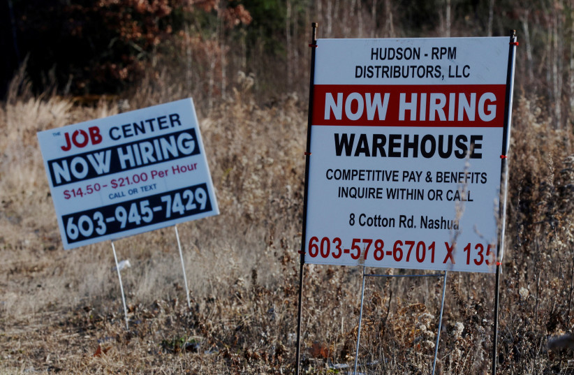 "Now Hiring" signs for jobs stand along a road in Londonderry, New Hampshire, US, November 29, 2021. (photo credit: REUTERS/BRIAN SNYDER/FILE PHOTO)