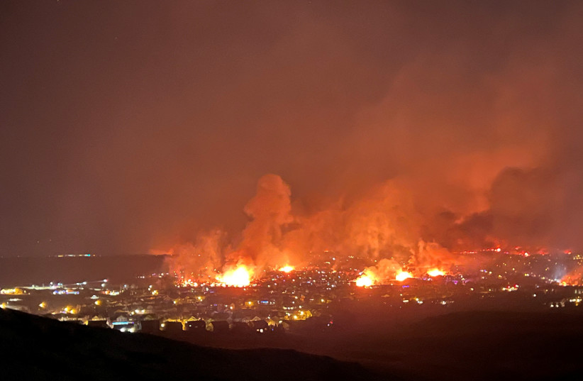 Buildings burn as a wind-driven grass fire destroys hundreds of homes, displaces thousands, as seen from Denver, Colorado, US, December 30, 2021. (photo credit: GREGG CORELLA/HANDOUT VIA REUTERS)