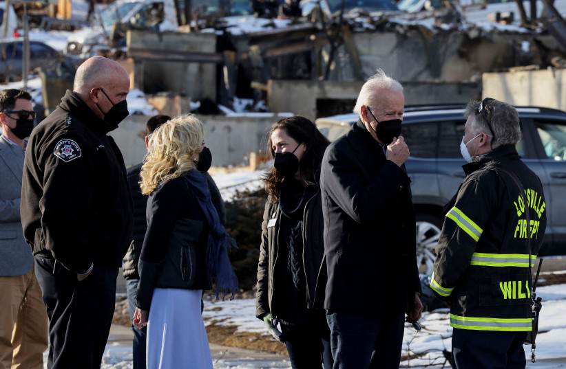 US President Joe Biden speaks with Louisville Fire Protection District Chief John Wilson as he and first lady Jill Biden tour a neighborhood in Louisville, Colorado, US, January 7, 2022. (credit: REUTERS/EVELYN HOCKSTEIN)