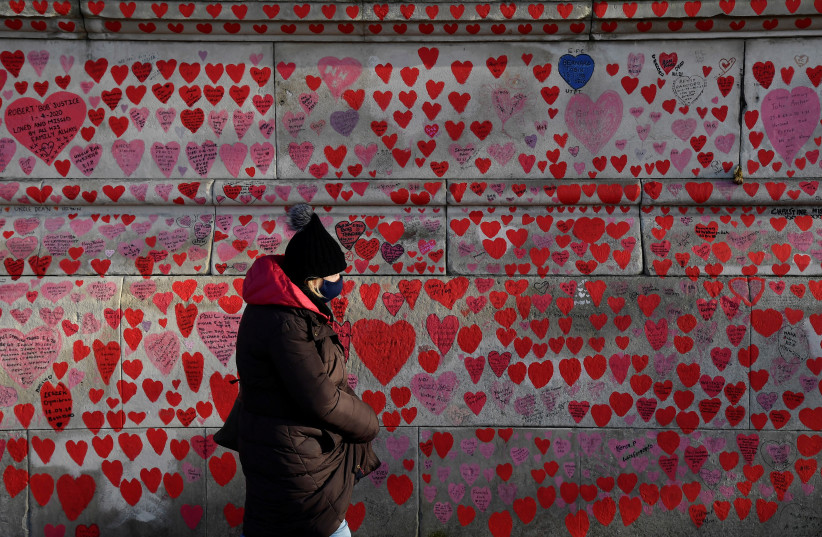  National Covid Memorial Wall, a dedication of thousands of hand-painted hearts and messages for those in the UK who have died from COVID-19, is seen amid the coronavirus disease pandemic in London (photo credit: REUTERS/TOBY MELVILLE)