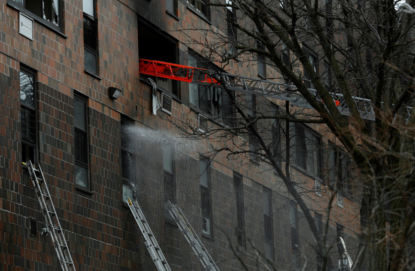 Emergency personnel from the FDNY respond to an apartment building fire in the Bronx borough of New York City, US, January 9, 2022. (credit: REUTERS/LLOYD MITCHELL)
