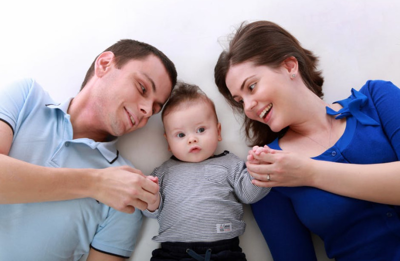  Parents with their child (Illustrative) (photo credit: Wikimedia Commons)