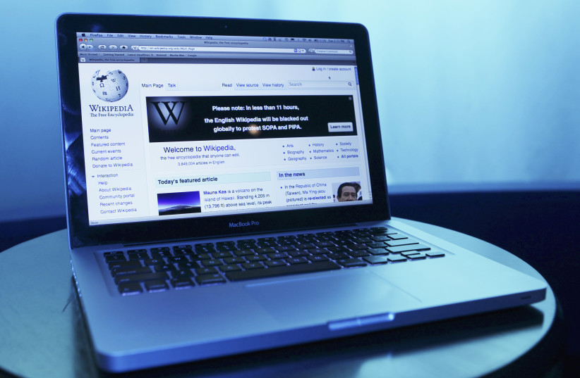  Wikipedia webpage in use on a laptop computer is seen in this photo illustration taken in Washington, January 17, 2012 (credit: REUTERS/GARY CAMERON)