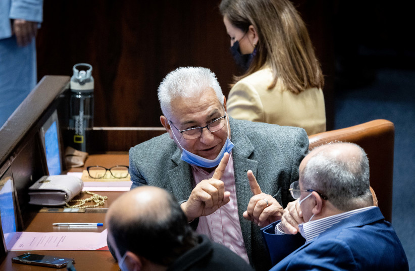  Ra'am MK Mazen Ghanaim is seen speaking with Joint List MK Ahmad Tibi in the Knesset, on January 5, 2022. (credit: YONATAN SINDEL/FLASH90)