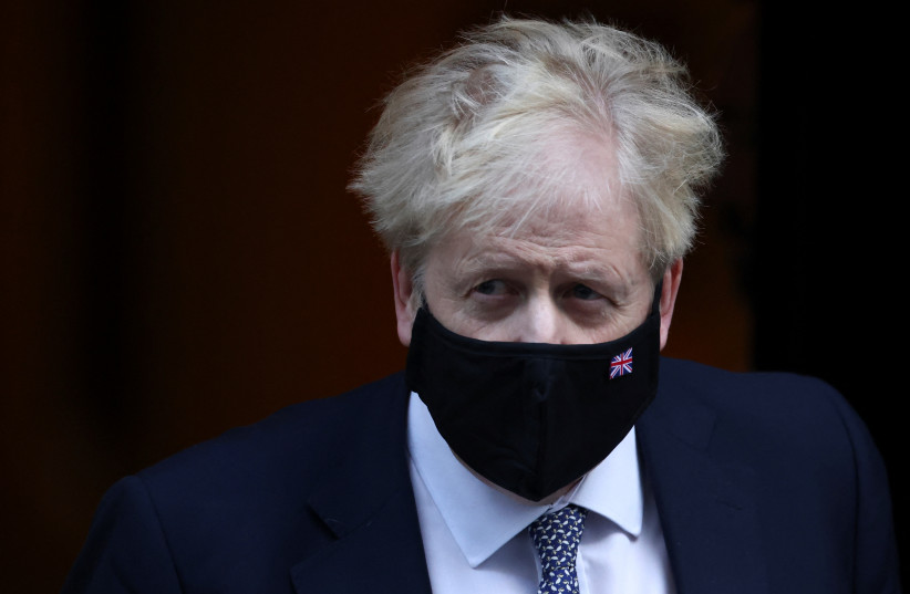British Prime Minister Boris Johnson walks outside Downing Street in London, Britain, January 12, 2022. (credit: REUTERS/HENRY NICHOLLS)