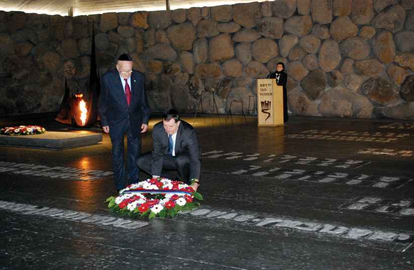  Dodik, alongside Arie Livne, lays a wreath at Yad Vashem during a 2010 visit to Israel. (credit: BORISLAV ZDRINJA)