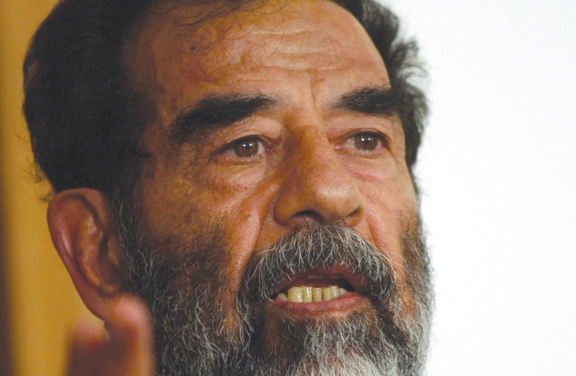  Former Iraqi leader Saddam Hussein addresses the court at his trial in 2004. (credit: WIKIPEDIA)