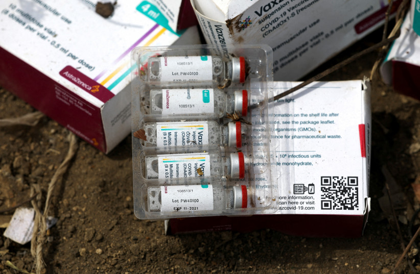The expiry date '11-2021' is seen on a vial of the AstraZeneca coronavirus disease (COVID-19) vaccine at the Gosa dump site in Abuja, Nigeria, December 22, 2021. (credit: REUTERS/AFOLABI SOTUNDE/FILE PHOTO)
