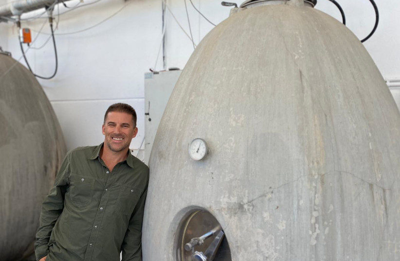  CALIFORNIA-BORN winemaker Ari Erle with his concrete egg. (credit: Bat Shlomo Vineyards)