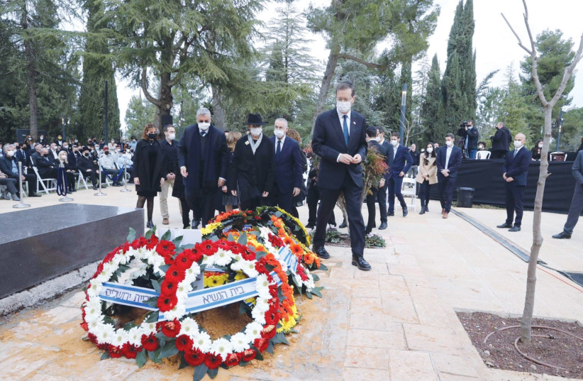 Members of the Herzog family move forward to place stones on the grave of Aura Herzog, following the wreath-laying ceremony. (photo credit: MARC ISRAEL SELLEM/THE JERUSALEM POST)