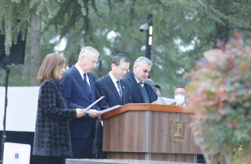 The Herzog siblings – Ronit, Michael, Isaac and Yoel – recite ‘Kaddish’ at the funeral of their mother, Aura Herzog. (credit: MARC ISRAEL SELLEM/THE JERUSALEM POST)