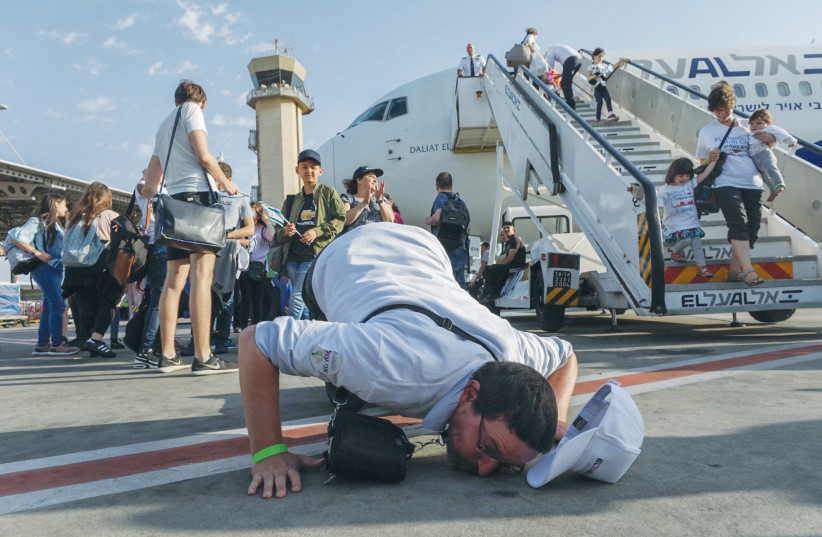 A man kisses the ground as new olim arrive at Ben-Gurion Airport. (photo credit: NATI SHOHAT/FLASH90)