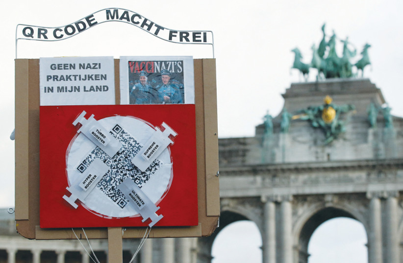 A Nazi-themed anti-vaccination placard is displayed during a demonstration this past week in Brussels against the Belgian government’s restrictions to contain the pandemic. (credit: JOHANNA GERON/REUTERS)
