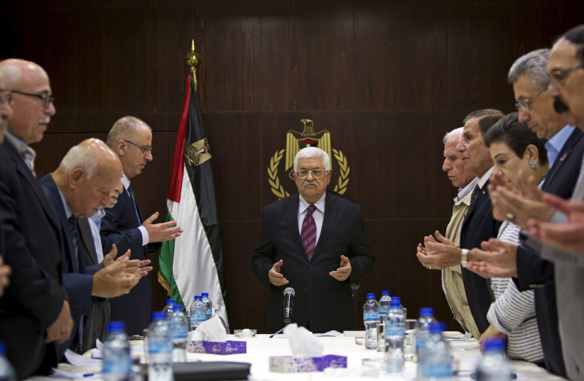 Palestinian President Mahmoud Abbas (C), joins a reading of the Koran prior to a meeting of the Palestinian Liberation Organization (PLO) executive committee in the West Bank city of Ramallah, August 22, 2015.  (photo credit: MAJDI MOHAMMED/POOL VIA REUTERS)