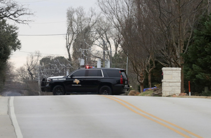  A law enforcement vehicle blocks the street where a man has reportedly taken people hostage at a synagogue during services that were being streamed live, in Colleyville, Texas, US (photo credit: REUTERS/Shelby Tauber)
