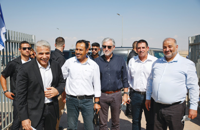  FOREIGN MINISTER Yair Lapid (front left), MK Mansour Abbas (front right) and other officials visit a school in the Neve Midbar region of the Negev. (photo credit: FLASH90)