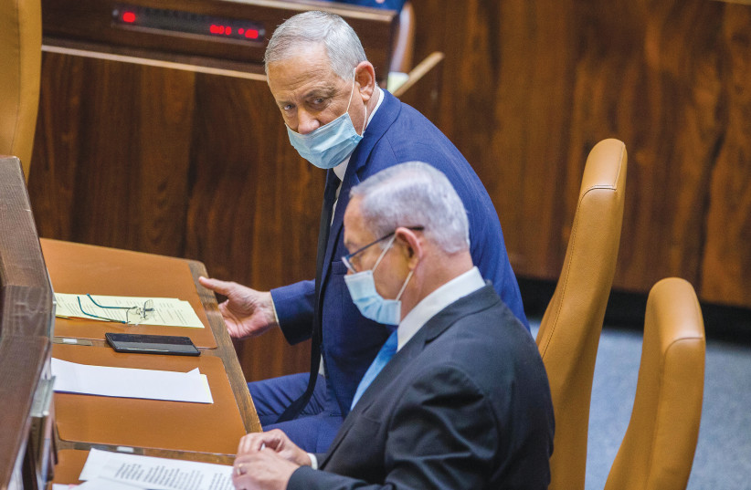  THEN-PRIME MINISTER Benjamin Netanyahu and Defense Minister Benny Gantz sit at the government table in the Knesset plenum in this photo from 2020. The formation of the Netanyahu-Gantz coalition created an unprecedented form of government.  (photo credit: OREN BEN HAKOON/FLASH90)