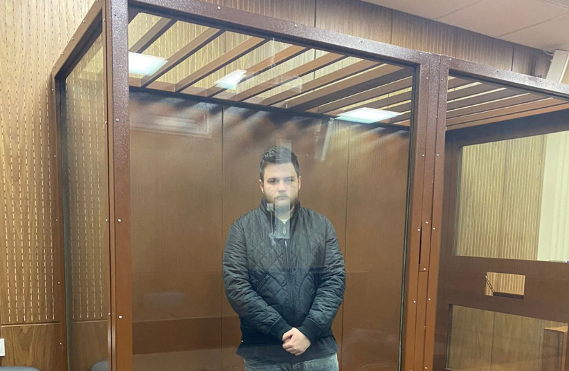 Alexei Malozemov, detained on suspicion of the illegal circulation of means of payment as a member of the REvil ransomware crime group, stands inside a defendants' cage during a court hearing in Moscow, Russia, January 15, 2022. (credit: PRESS SERVICE OF TVERSKOY DISTRICT COURT OF MOSCOW/HANDOUT VIA REUTERS)