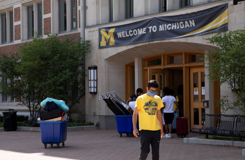 Students move back into the dorm for fall semester amid the coronavirus disease (COVID-19) pandemic at the University of Michigan campus in Ann Arbor, Michigan, US, August 19, 2020. (photo credit: REUTERS/EMILY ELCONIN)