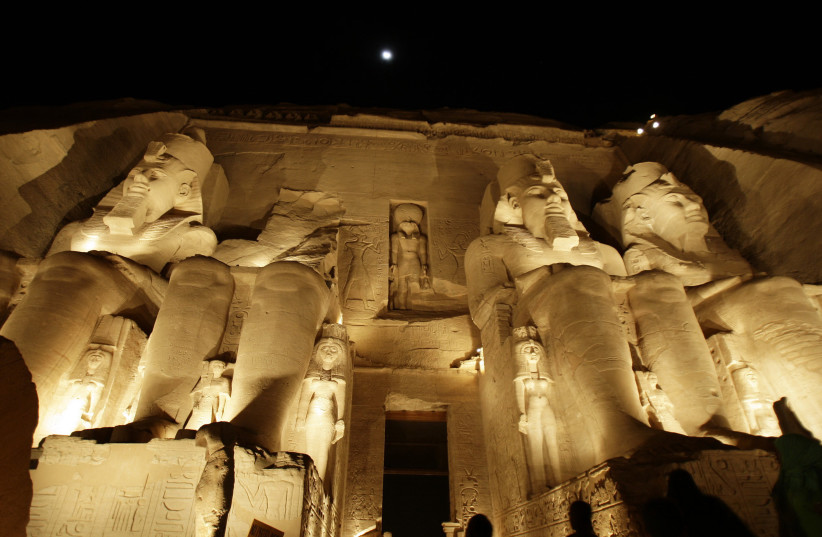  Tourists look at the 3200-year-old Abu Simbel temple during a daily sound and light show, on the eve of the anniversary of pharaoh king Ramses II's coronation. (photo credit: REUTERS/AMR ABDALLAH DALSH)