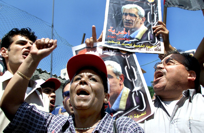  Palestinians from the Popular Front for the Liberation of Palestine (PFLP) celebrate the decision of the Palestinian Authority's High Court, which ordered the release on Monday their leader Ahmed Sa'adat, out side the court in Gaza Strip June 3, 2002. (credit:  REUTERS/Ahmed Jadallah AJ/CRB)