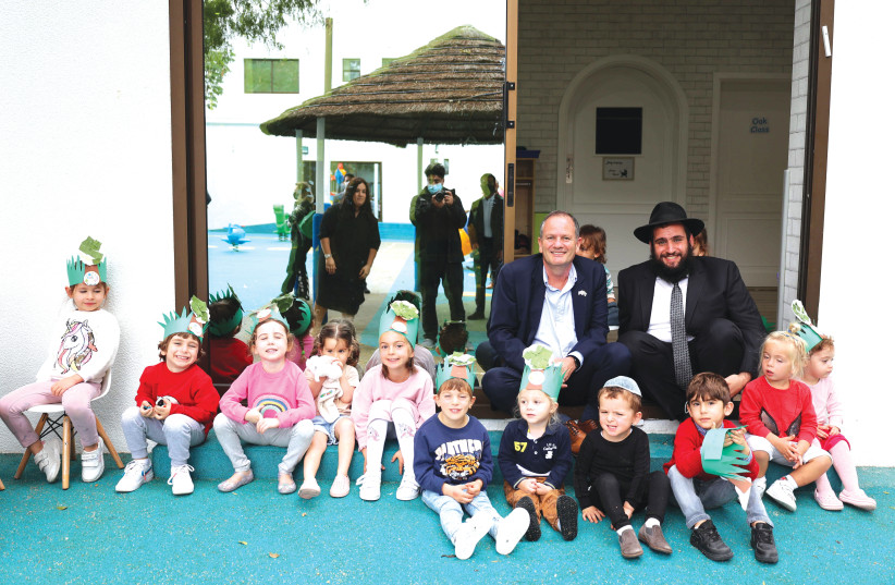  UAE JEWISH community leader Rabbi Levi Duchman (right) and Israeli Consul-General in Dubai Ilan Sztulman with children of the Jewish community on Tu Bishvat. (photo credit: JEWISH UAE)