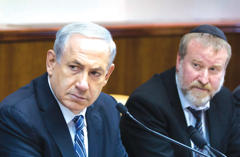  THEN-PRIME MINISTER Benjamin Netanyahu and then-cabinet secretary Avichai Mandelblit sit alongside each other a cabinet meeting in 2014. (photo credit: YONATAN SINDEL/FLASH90)