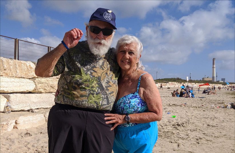 Joel Tenenbaum, 81, and Marilyn Berkowitz, 84, enjoy the beach just north of Tel Aviv.  (photo credit: Courtesy)