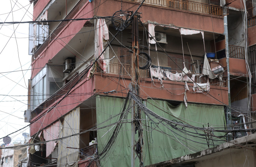  Electricity cables and torn balcony covers are pictured in Bourj Hammoud, Lebanon January 27, 2021.  (credit: MOHAMED AZAKIR/REUTERS)