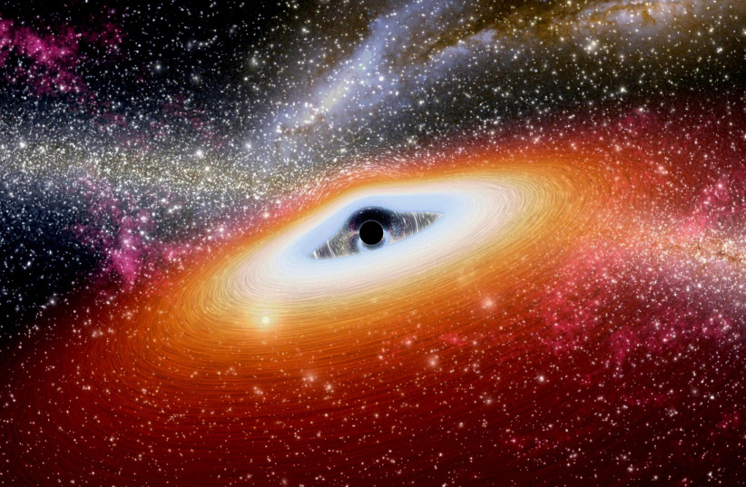  A supermassive black hole is seen in the center of a galaxy (illustrative). (photo credit: PIXABAY)