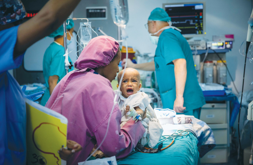  A MOTHER holds her child who is about to undergo open-heart surgery at the Children’s Cardiac Center in Addis Ababa, during a Save a Child’s Heart mission in 2019. (photo credit: YONATAN SINDEL/FLASH90)