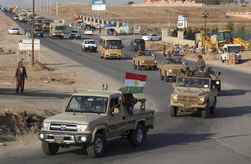 A convoy of Kurdish peshmerga fighters drive through Arbil after leaving a base in northern Iraq, on their way to the Syrian town of Kobani, October 28, 2014. (credit: REUTERS/AZAD LASHKARI)