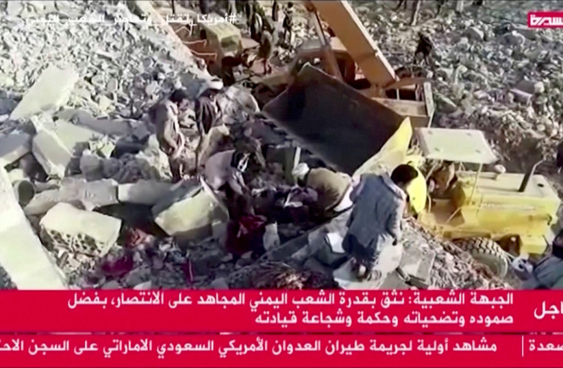  Rescue workers pull a body from rubble after an airstrike hit a temporary detention centre in Saada, Yemen. (photo credit: Al Masirah TV/REUTERS TV via REUTERS)
