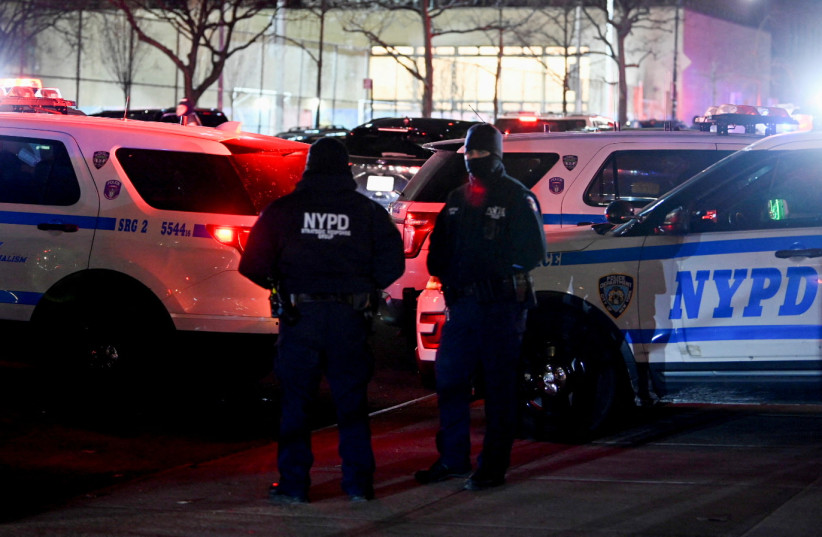 Emergency personnel respond at the scene where NYPD officers were shot while responding to a domestic violence call in the Harlem neighborhood of New York City, US, January 21, 2022. (credit: REUTERS/LLOYD MITCHELL)