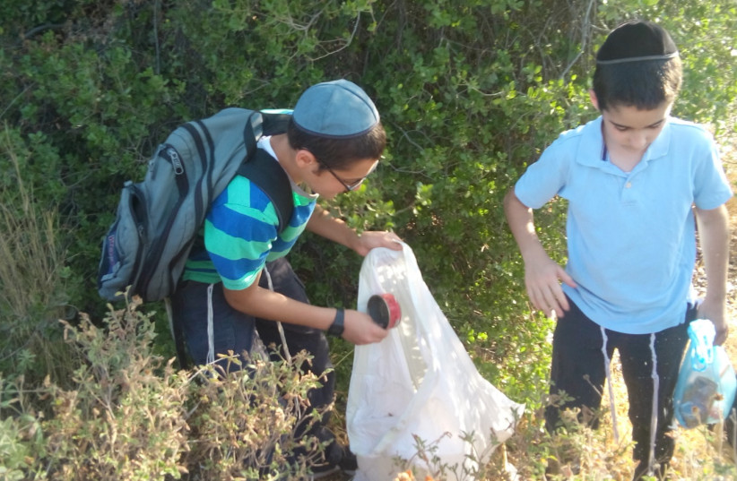 Children participate in an activity of Leshomra, likely the largest Haredi environmental organization currently operating in Israel. (photo credit: COURTESY LESHOMRA)