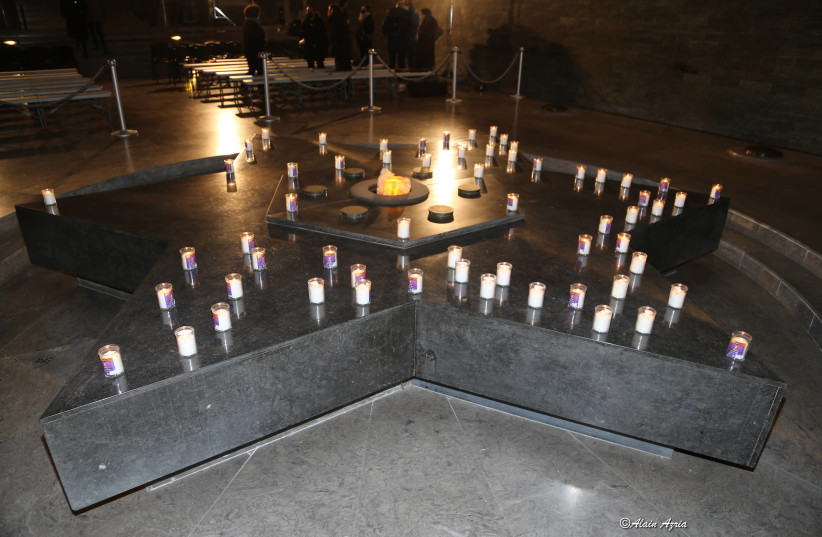 Memorial candles and a Star of David are displayed at a ceremony in Paris marking 80 years since the Wannsee Conference, on January 20, 2022. (credit: ALAIN AZRIA)
