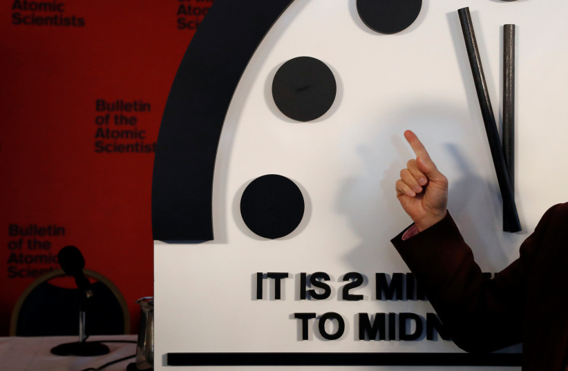  Lawrence Krauss, a member of the Bulletin of the Atomic Scientists, talks to a reporter about their decision to move the 'Doomsday Clock' hands to two minutes until midnight after a news conference in Washington, US, January 25, 2018. (credit: LEAH MILLIS/REUTERS)