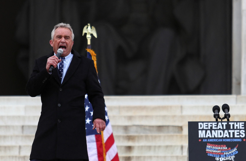 Robert F. Kennedy Jr. speaks during a rally following a march in opposition to coronavirus disease (COVID-19) mandates on the National Mall, in Washington, DC, US, January 23, 2022. (credit: REUTERS/TOM BRENNER)