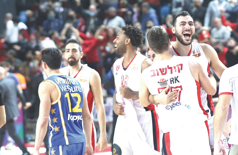  HAPOEL TEL AVIV players celebrate on the court at the conclusion of their 78-77 victory over city rival Maccabi Tel Aviv in the Israel Winner League derby on Sunday night. (photo credit: DANNY MARON)