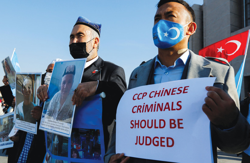  ETHNIC UIGHUR men take part in a protest against China, in Istanbul earlier this month. (photo credit: DILARA SENKAYA/REUTERS)