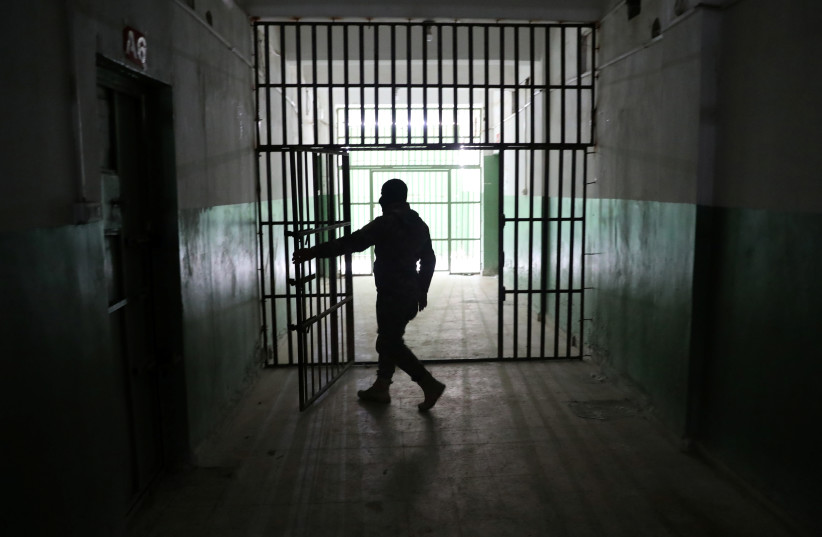  A guard opens a door inside a prison that holds foreign prisoners, suspected of being part of the Islamic State, in Hasaka, Syria, January 7, 2020.  (photo credit: GORAN TOMASEVIC/REUTERS)