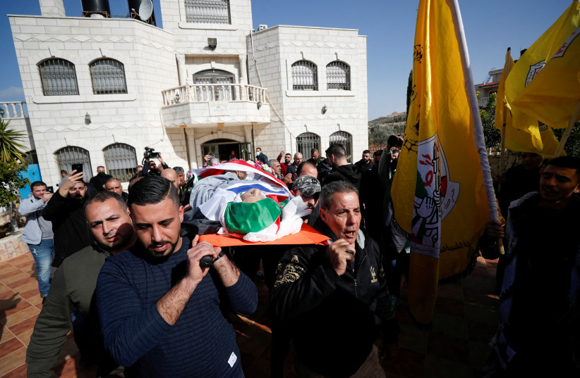  Mourners attend the funeral of Palestinian-American Omar Abdalmajeed As'ad, 80, who was found dead after being detained and handcuffed during an Israeli raid, in Jiljilya village in the Israeli-occupied West Bank, January 13, 2022.  (photo credit: MOHAMAD TOROKMAN/REUTERS)
