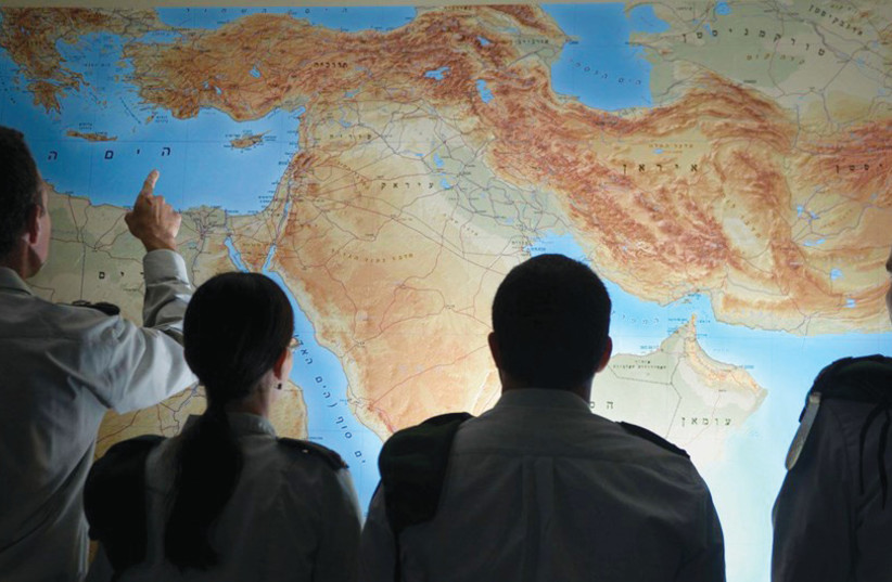  OFFICERS LOOK at a map of the Middle East. (photo credit: IDF SPOKESPERSON'S UNIT)