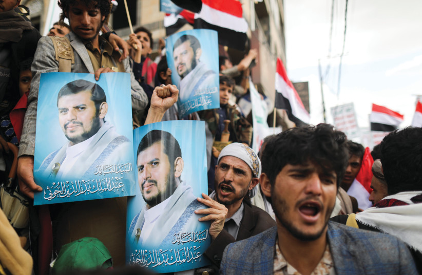  BRANDISHING POSTERS of top Houthi leader Abdul Malik al-Houthi to celebrate the seventh anniversary of the ousting of the government, in Sana’a, Yemen, September 21. (credit: KHALED ABDULLAH/REUTERS)