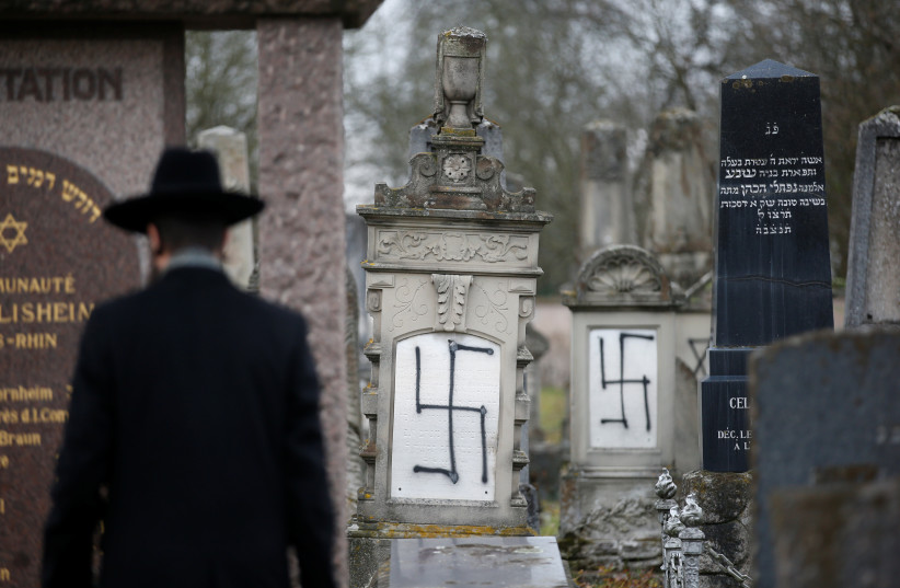  Strasbourg's Grand Rabbi Weill inspects graves desecrated with swastikas in the Jewish cemetery of Herrlisheim (photo credit: REUTERS/VINCENT KESSLER)