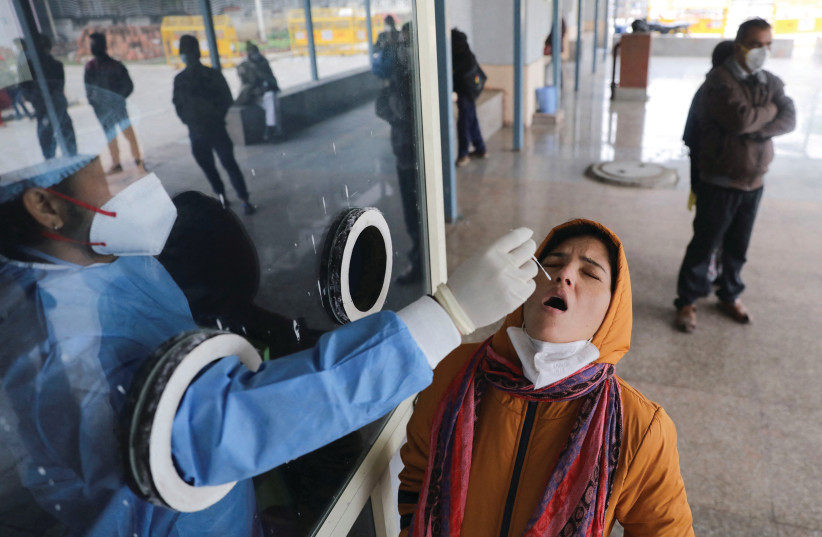  A WOMAN takes a COVID-19 test at a hospital in New Delhi, earlier this month. When India suffered a severe COVID-19 wave last April, Israel sent planeloads of respirators and other medical aid. (photo credit: REUTERS/ANUSHREE FADNAVIS)