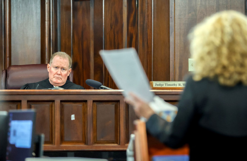  Superior Court Judge Timothy Walmsley, left, listens to Greg McMichael's attorney Laura Hogue, right, during the sentencing of Greg McMichael and his son, Travis McMichael, and a neighbor, William "Roddie" Bryan at the Glynn County Courthouse, Brunswick, Ga. U.S., Friday, January 7, 2022. (photo credit: POOL VIA REUTERS)