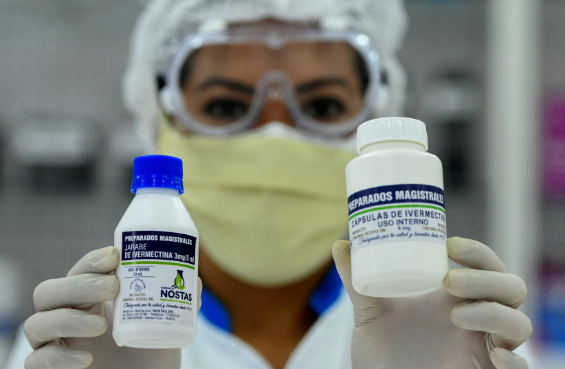  FILE PHOTO: A pharmacist holds the anti-parasite drug ivermectin for sale to the public with a medical prescription as Bolivia's Ministry of Health said it can be used under proper medical protocol. Santa Cruz, Bolivia May 19, 2020. (photo credit: REUTERS/Rodrigo Urzagasti/File Photo)